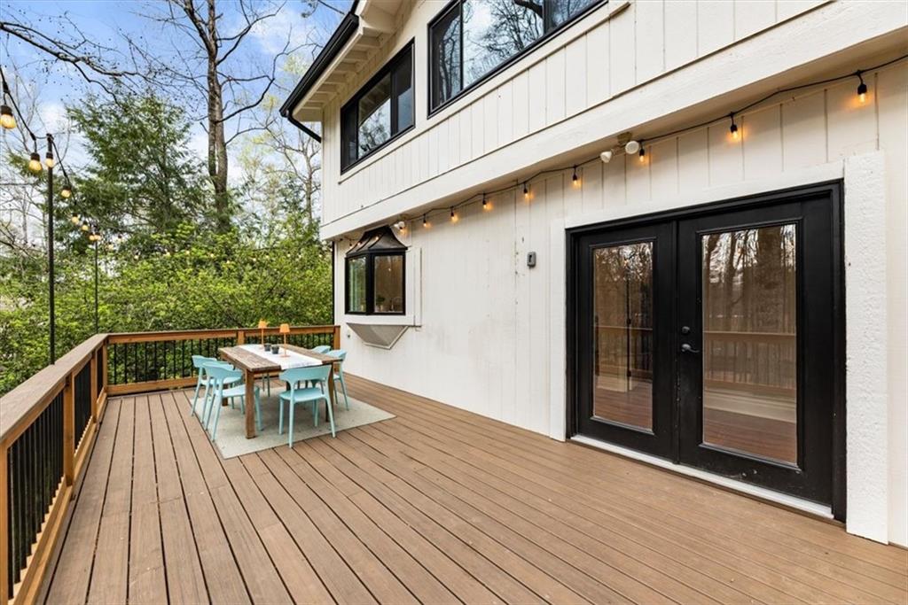 2415 Roxburgh Drive Roswell, GA 30076 - Photo 46 of 62 a view of a patio with table and chairs and floor to ceiling window with wooden floor