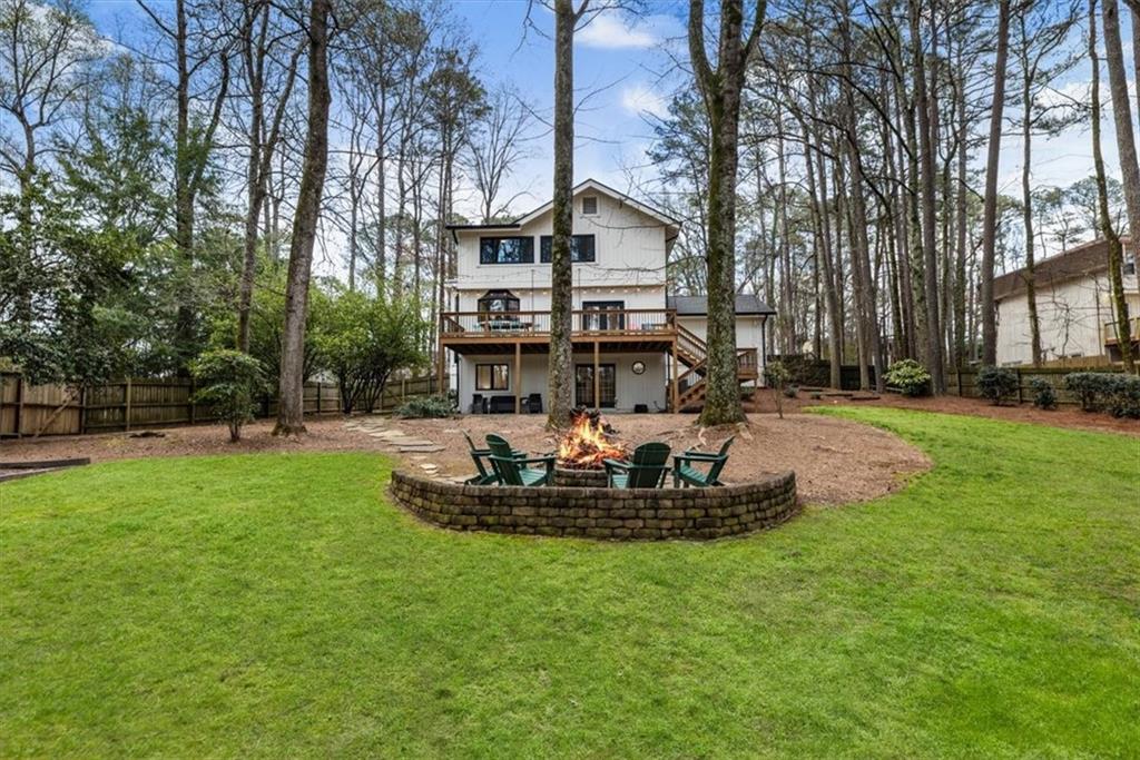 2415 Roxburgh Drive Roswell, GA 30076 - Photo 50 of 62 a front view of a house with a yard and trees