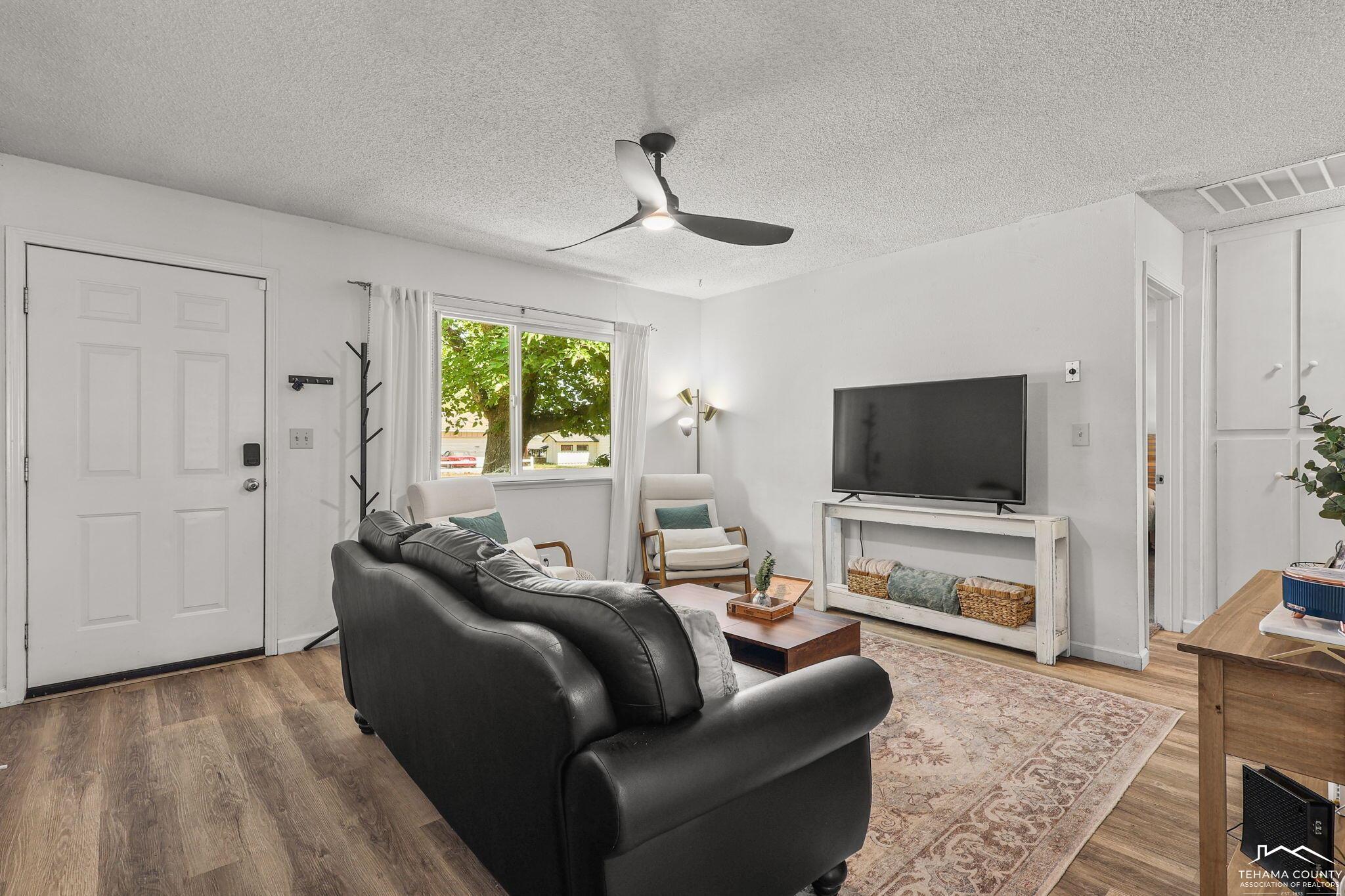 22275 Brent Road Red Bluff, CA 96080 - Photo 6 of 47 a living room with furniture and a flat screen tv