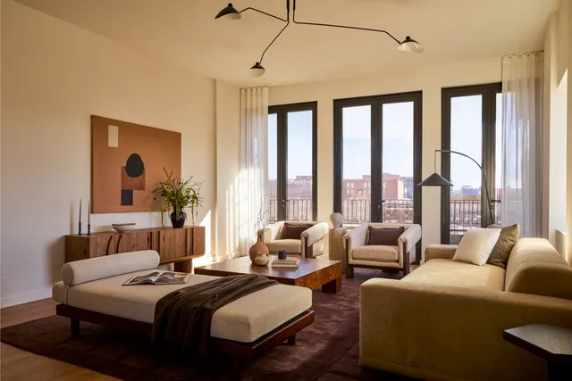 a bedroom with beds and a large window