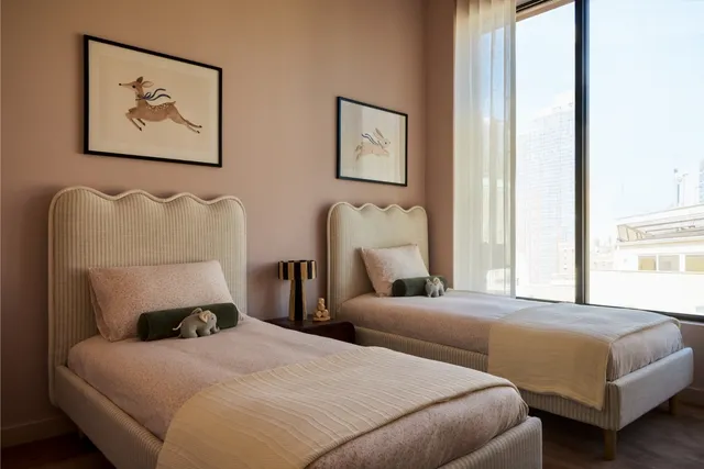 a bedroom with a bed and a painting on the wall