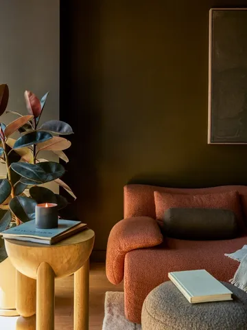 a table with chairs and a vase of flowers