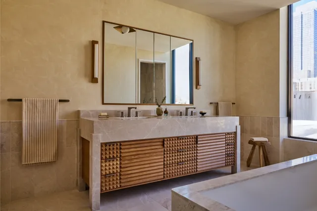 a bathroom with a double vanity sink and a mirror