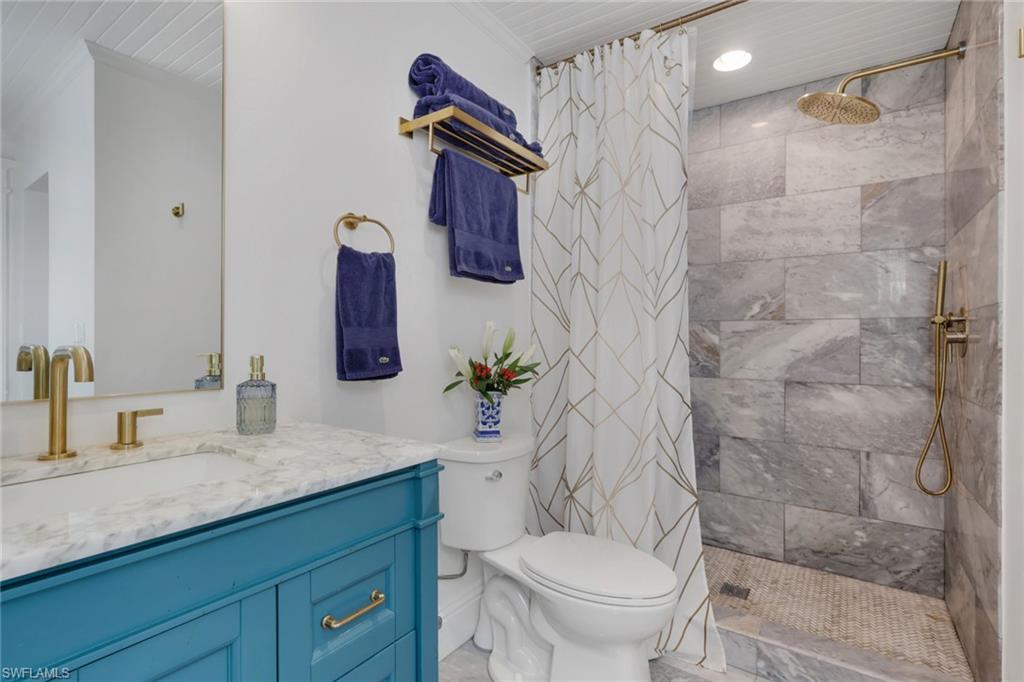 2582 First Street Fort Myers, FL 33901 - Photo 21 of 35 a bathroom with a granite countertop sink toilet and shower