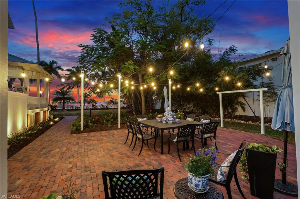 2582 First Street Fort Myers, FL 33901 - Photo 33 of 35 a view of a patio with dining table and chairs with a barbeque grill and plants