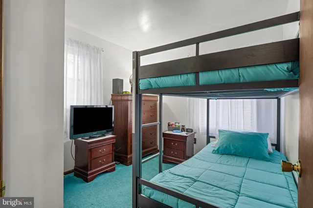 a bedroom with a bed closet and flat tv screen