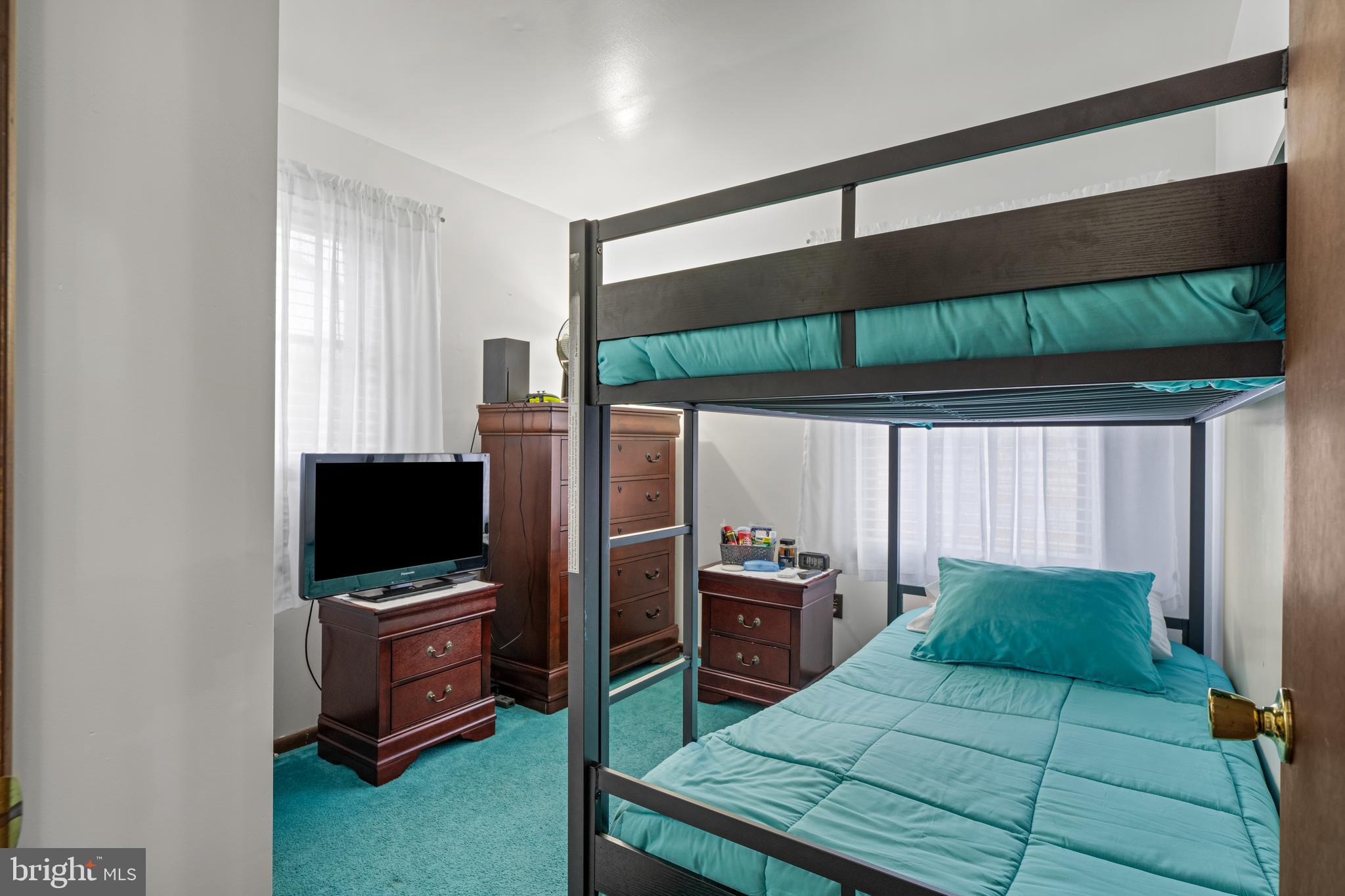 393 Newport Neck Road Newport, NJ 08345 - Photo 12 of 24 a bedroom with a bed closet and flat tv screen