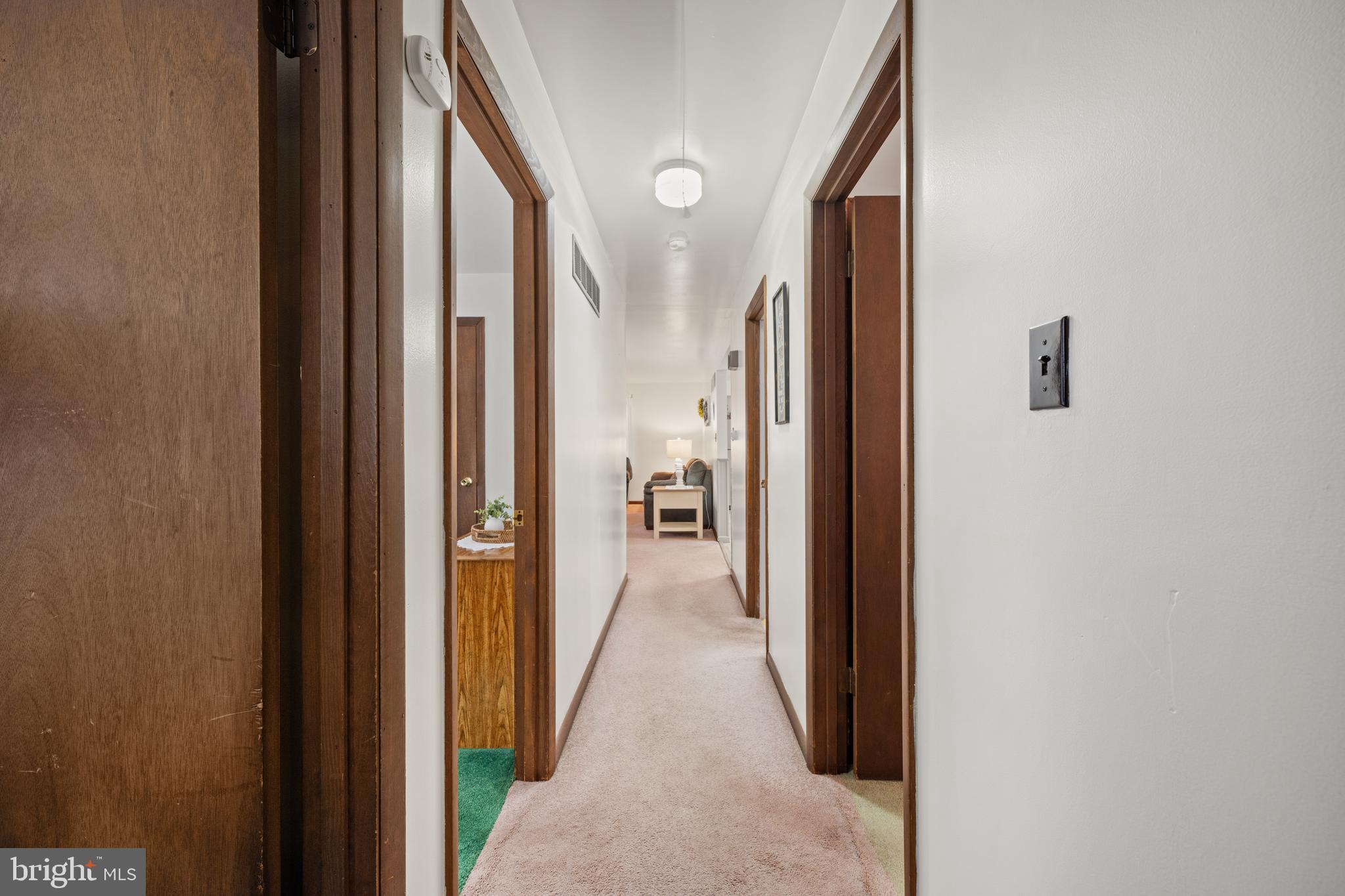 393 Newport Neck Road Newport, NJ 08345 - Photo 14 of 24 a view of a hallway with wooden floor and a bathroom