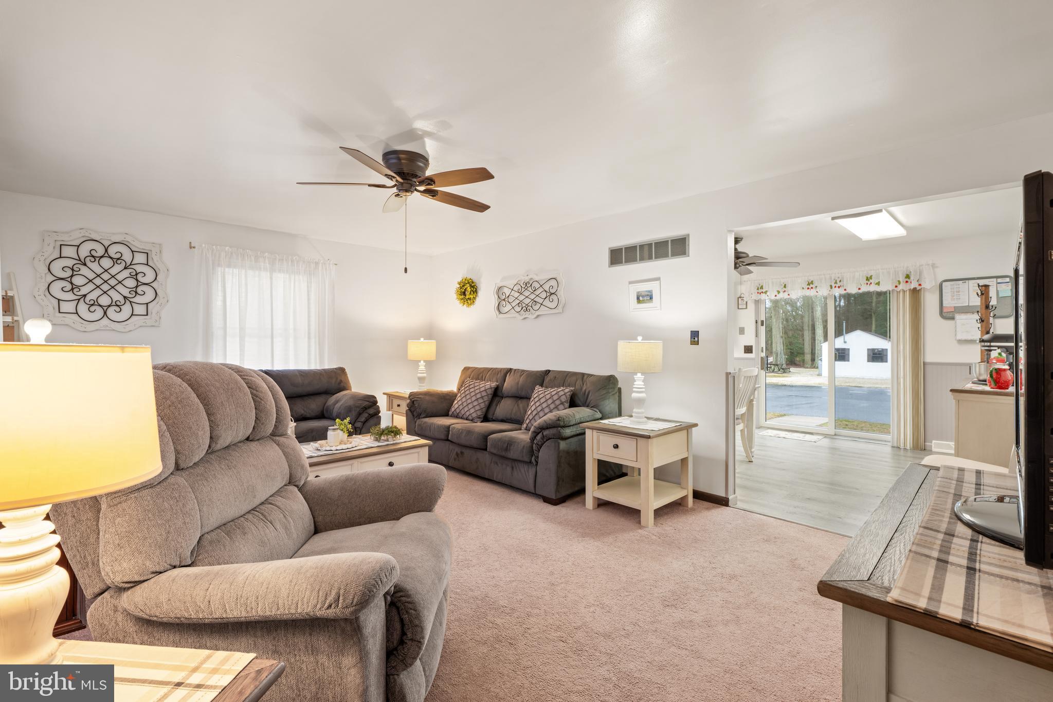 393 Newport Neck Road Newport, NJ 08345 - Photo 18 of 24 a living room with furniture a ceiling fan and a rug
