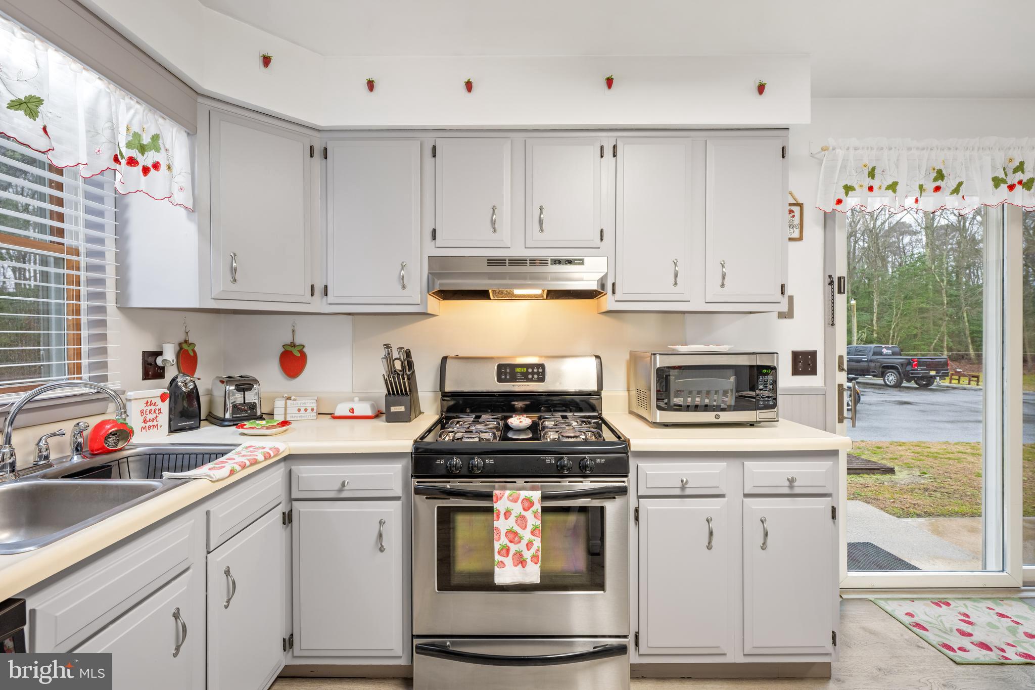 393 Newport Neck Road Newport, NJ 08345 - Photo 8 of 24 a kitchen with white cabinets and appliances
