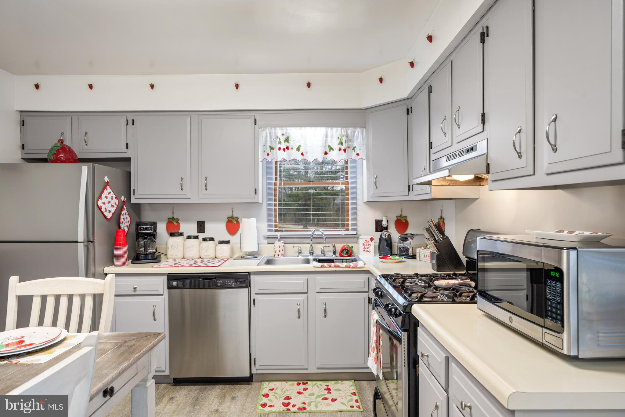 393 Newport Neck Road Newport, NJ 08345 - Photo 9 of 24 a kitchen with granite countertop a sink cabinets stainless steel appliances and a window
