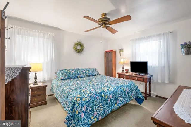 a bedroom with a bed furniture and a flat screen tv
