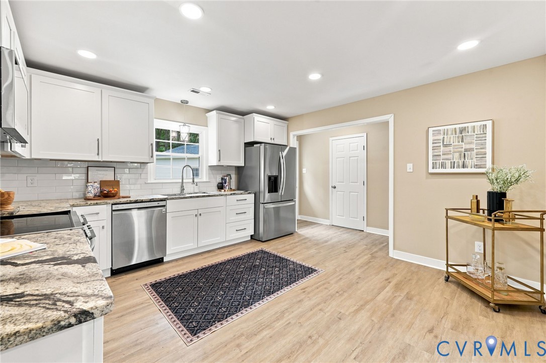 3221 Clintwood Road Midlothian, VA 23112 - Photo 22 of 46 Kitchen featuring wood-finish flooring, white cabi