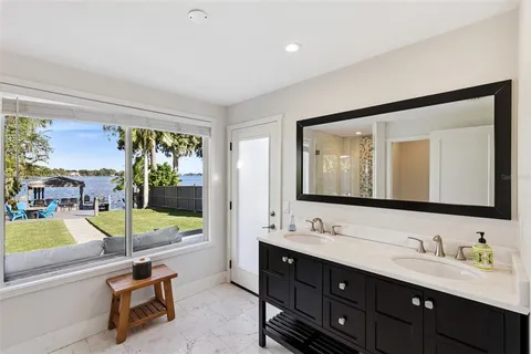 a bathroom with a tub sink and mirror