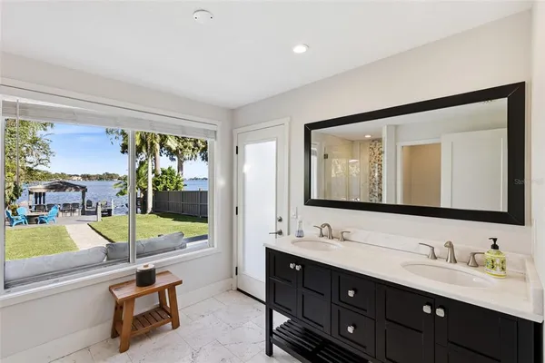 a bathroom with a tub sink and mirror