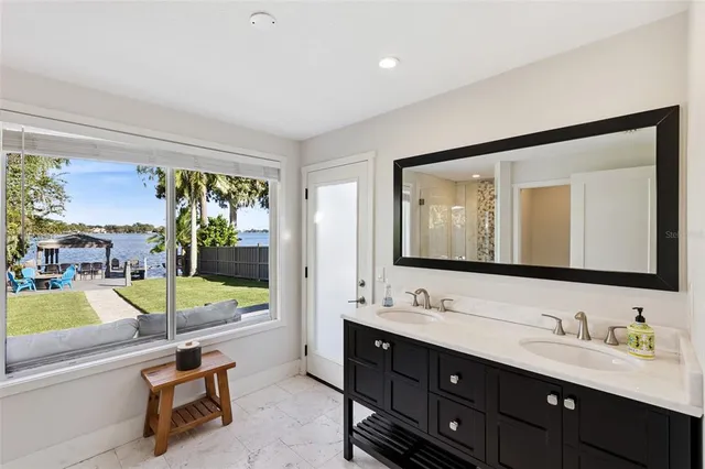 a bathroom with a tub sink and mirror