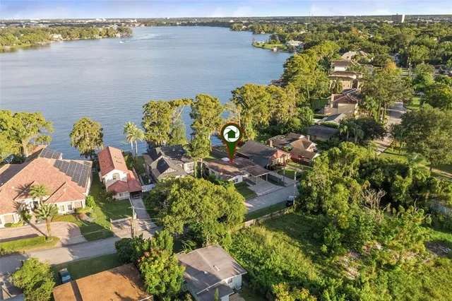 an aerial view of a house with a lake view