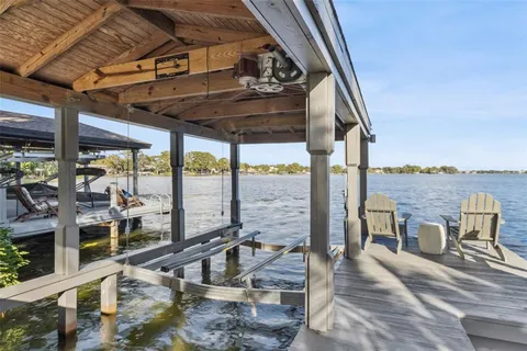 a view of a living room with a floor to ceiling window and wooden floor