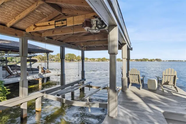 a view of a living room with a floor to ceiling window and wooden floor