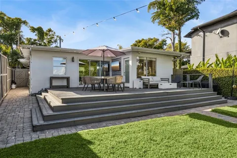 a front view of a house with a garden and patio