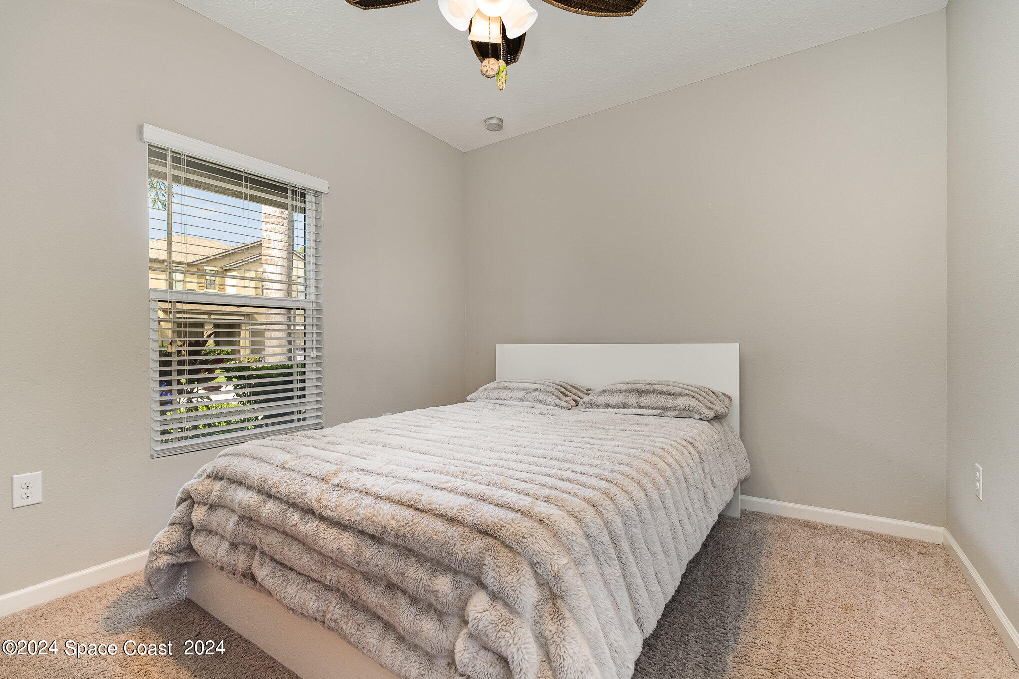 4210 Harvest Circle Rockledge, FL 32955 - Photo 16 of 24 a bedroom with a bed and a chandelier