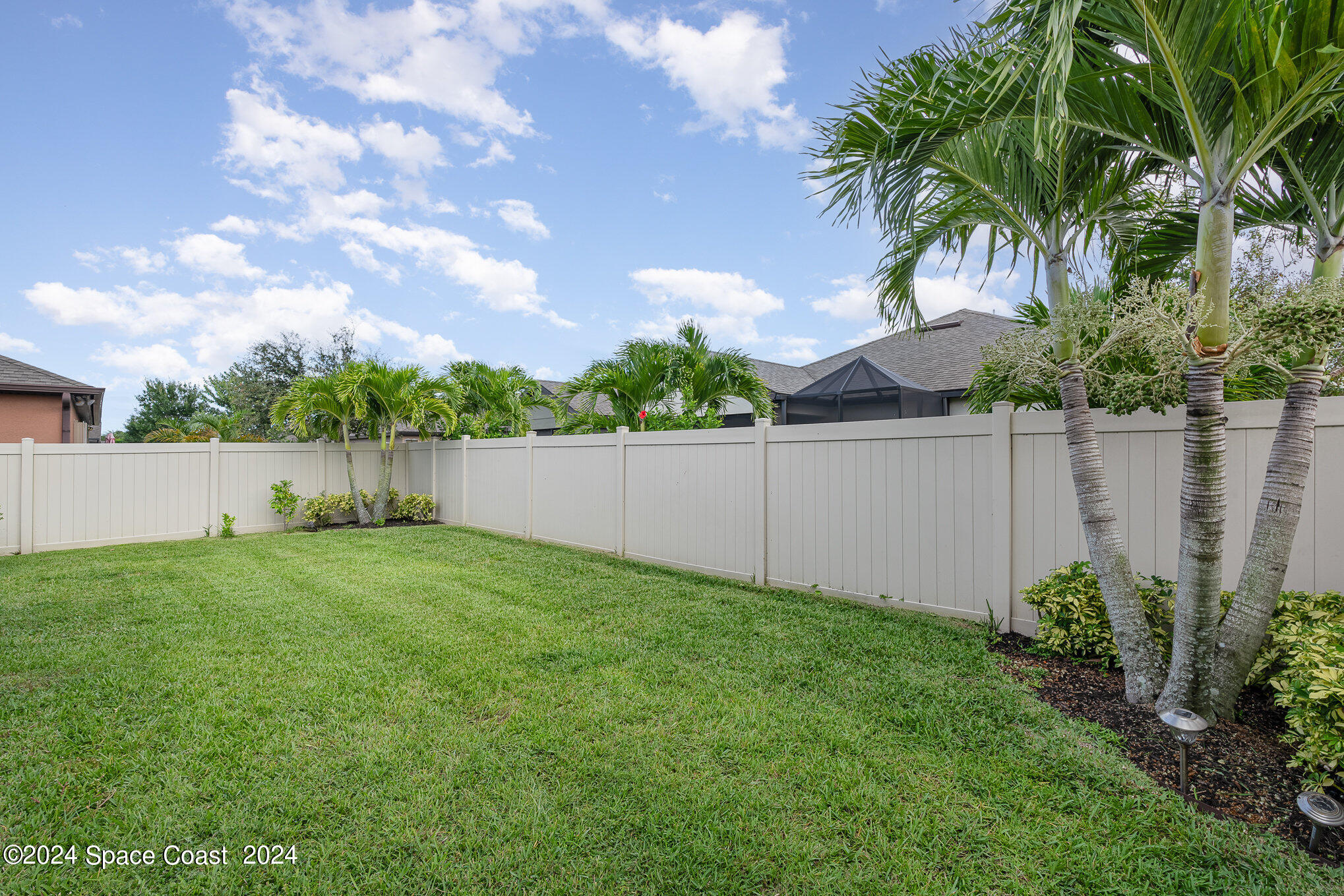 4210 Harvest Circle Rockledge, FL 32955 - Photo 23 of 24 a view of a backyard with a plants and trees