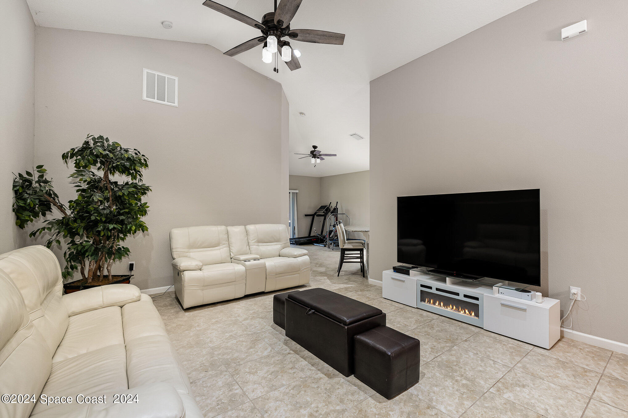 4210 Harvest Circle Rockledge, FL 32955 - Photo 4 of 24 a living room with furniture and a flat screen tv