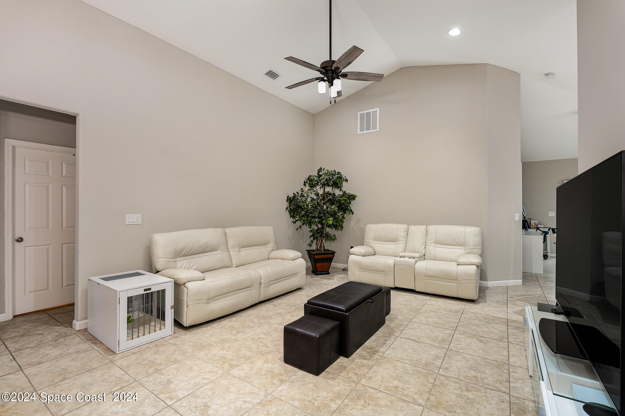 4210 Harvest Circle Rockledge, FL 32955 - Photo 5 of 24 a living room with furniture and a flat screen tv