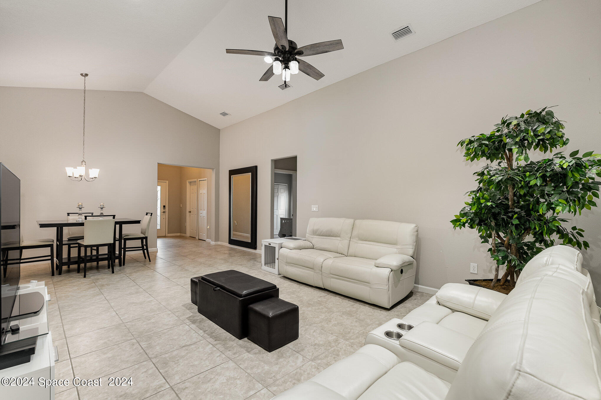 4210 Harvest Circle Rockledge, FL 32955 - Photo 6 of 24 a living room with furniture potted plant and a chandelier
