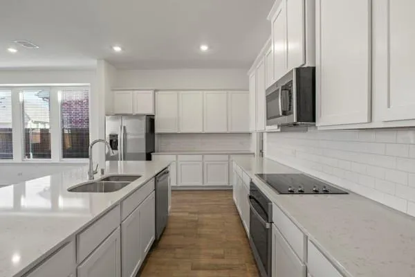 a kitchen with a sink stove and refrigerator