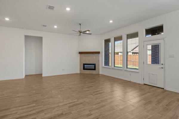 224 Cherryvale Lane Princeton, TX 75407 - Photo 12 of 28 a view of an empty room with a fireplace and a window