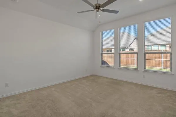 an empty room with closet and windows