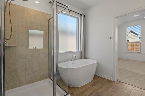 224 Cherryvale Lane Princeton, TX 75407 - Photo 24 of 28 a bathroom with a white bath tub sitting next to a shower
