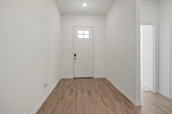 224 Cherryvale Lane Princeton, TX 75407 - Photo 4 of 28 a view of a room with wooden floor and white walls