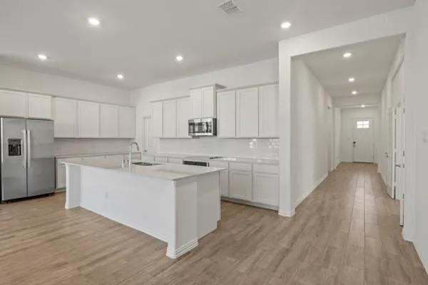 a kitchen with white cabinets and white stainless steel appliances