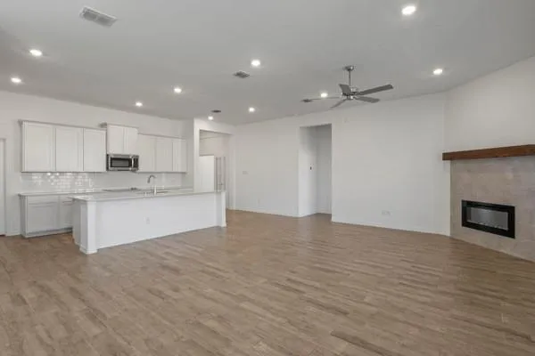 a large kitchen with kitchen island a sink stainless steel appliances and cabinets