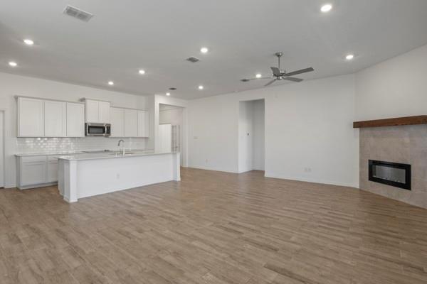 224 Cherryvale Lane Princeton, TX 75407 - Photo 8 of 28 a large kitchen with kitchen island a sink stainless steel appliances and cabinets
