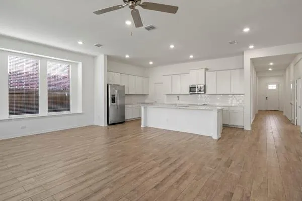a view of kitchen with refrigerator stove microwave and cabinets
