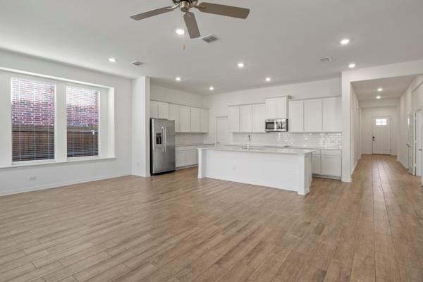 224 Cherryvale Lane Princeton, TX 75407 - Photo 9 of 28 a view of kitchen with refrigerator stove microwave and cabinets