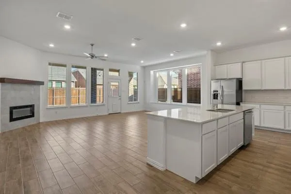 a large kitchen with stainless steel appliances granite countertop a large counter top and a stove