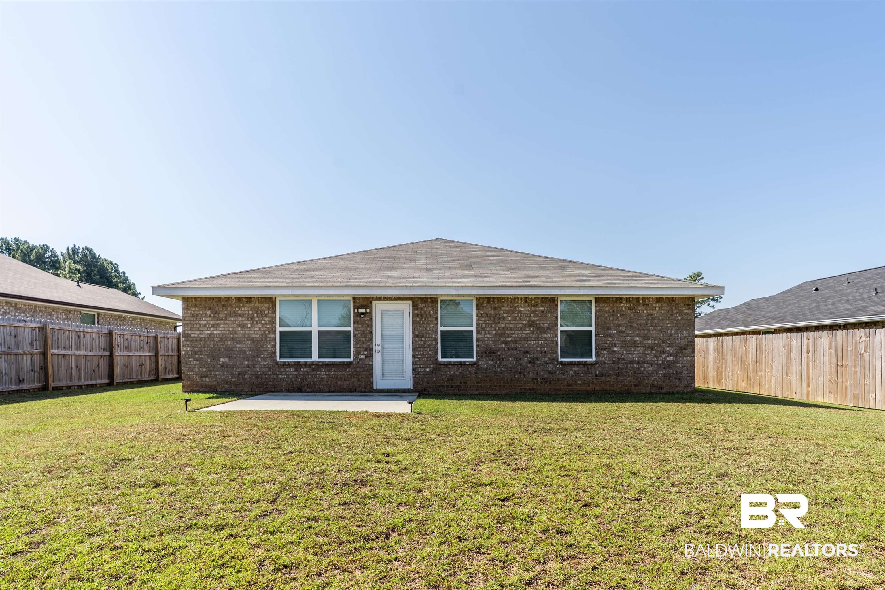 1906 Stonepine Drive South Semmes, AL 36575 - Photo 24 of 30 View of front facade featuring brick siding, a patio, and a fenced backyard