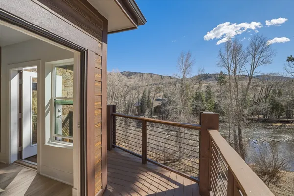 a view of a balcony with wooden floor and fence