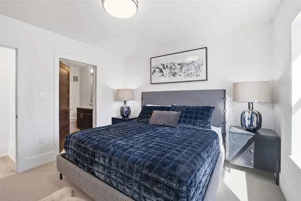 a bedroom with a bed and lamp