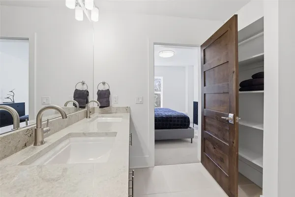 a en suite bathroom with a sink and a large mirror