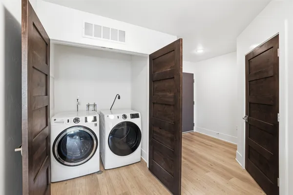 a view of a hallway with washer and dryer