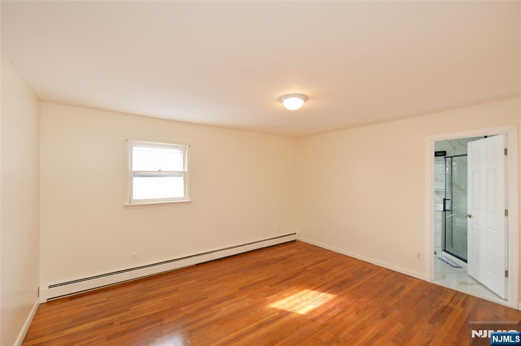 100 Eastern Way Rutherford, NJ 07070 - Photo 12 of 19 an empty room with wooden floor and windows