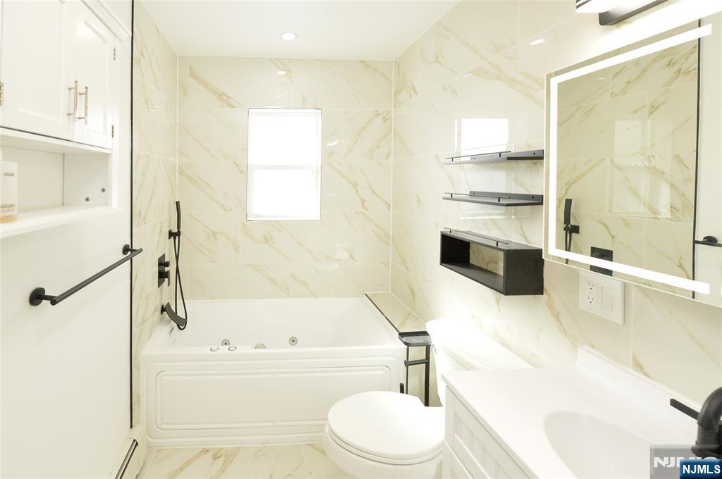 100 Eastern Way Rutherford, NJ 07070 - Photo 15 of 19 a bathroom with a bathtub toilet sink and shower