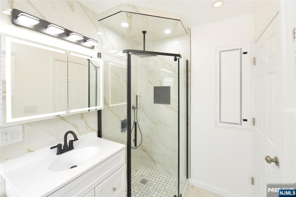 100 Eastern Way Rutherford, NJ 07070 - Photo 16 of 19 a bathroom with a sink and a mirror