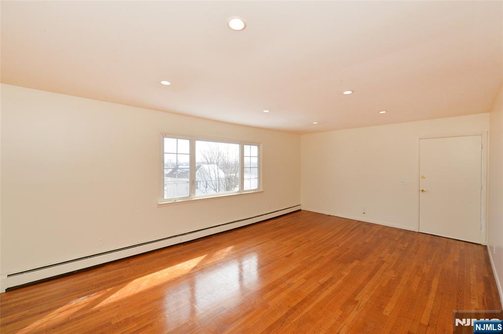 100 Eastern Way Rutherford, NJ 07070 - Photo 18 of 19 an empty room with wooden floor and windows