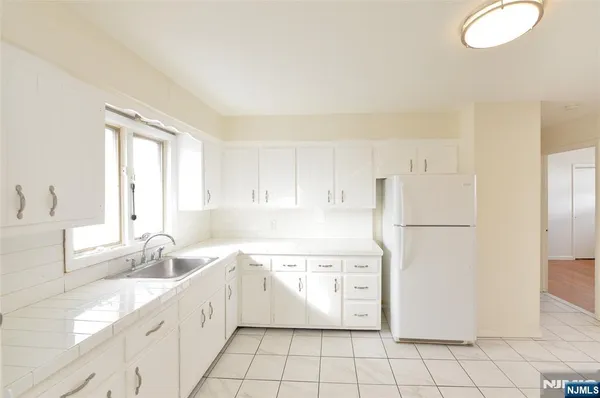 a kitchen with a white cabinets and white appliances